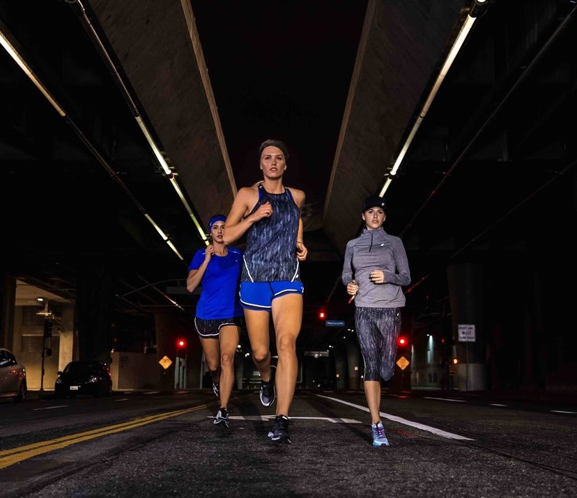 three women running at night; lite-show