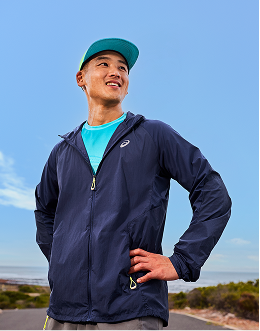 Man wearing blue sports jacket and cap