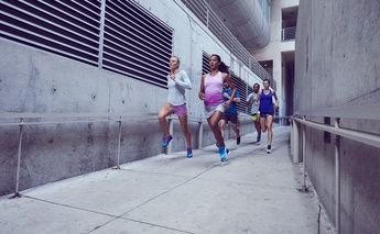 group of runners through cement hallway