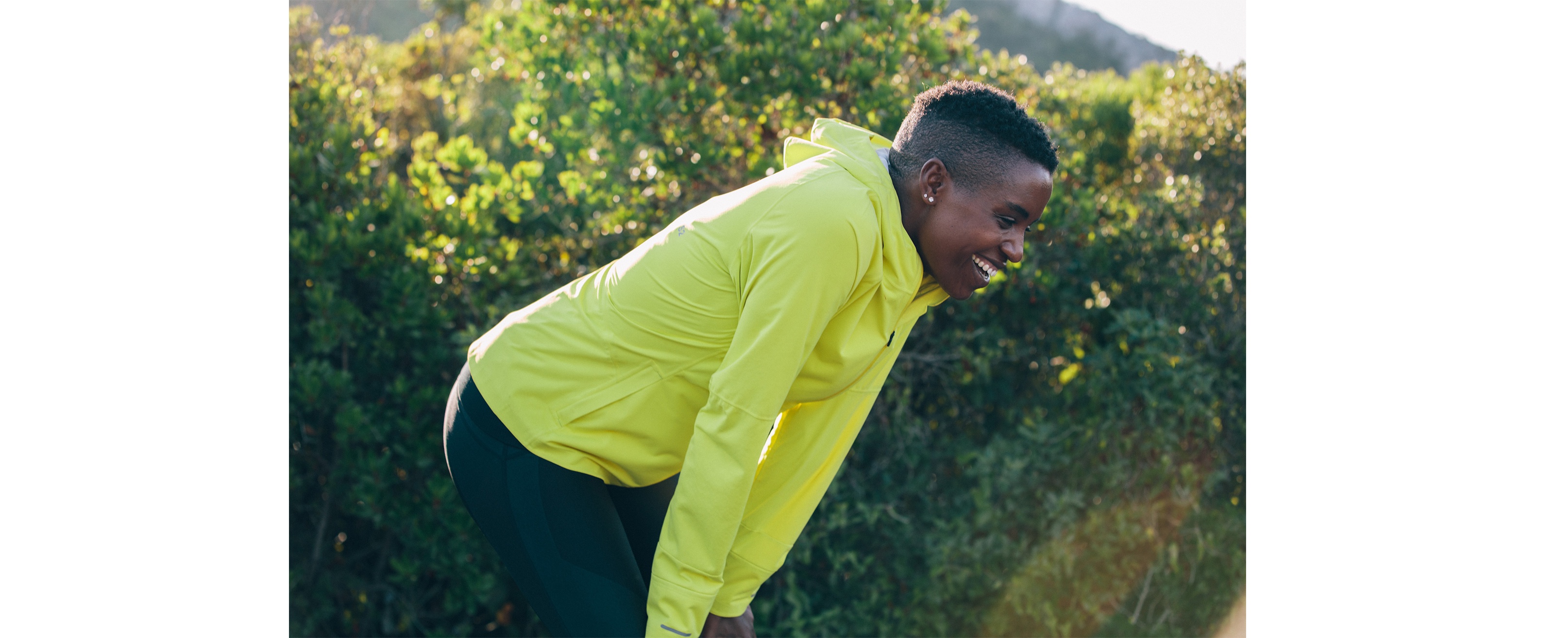 Diane Nukuri with her hands on her knees, catching her breath after a run.