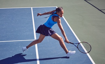 woman in blue playing tennis