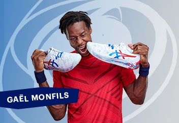 Gael Monfils holding a pair of tennis shoes
