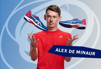 Alex De Minuar holding a pair of tennis shoes