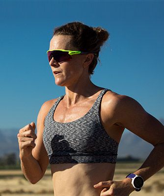 Flora Duffy, Triathlete, running outside wearing sunglasses.  