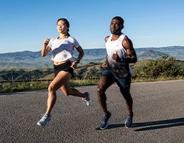 man and woman running on the road