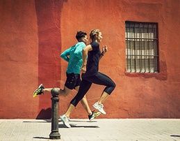 Man and woman running outside.