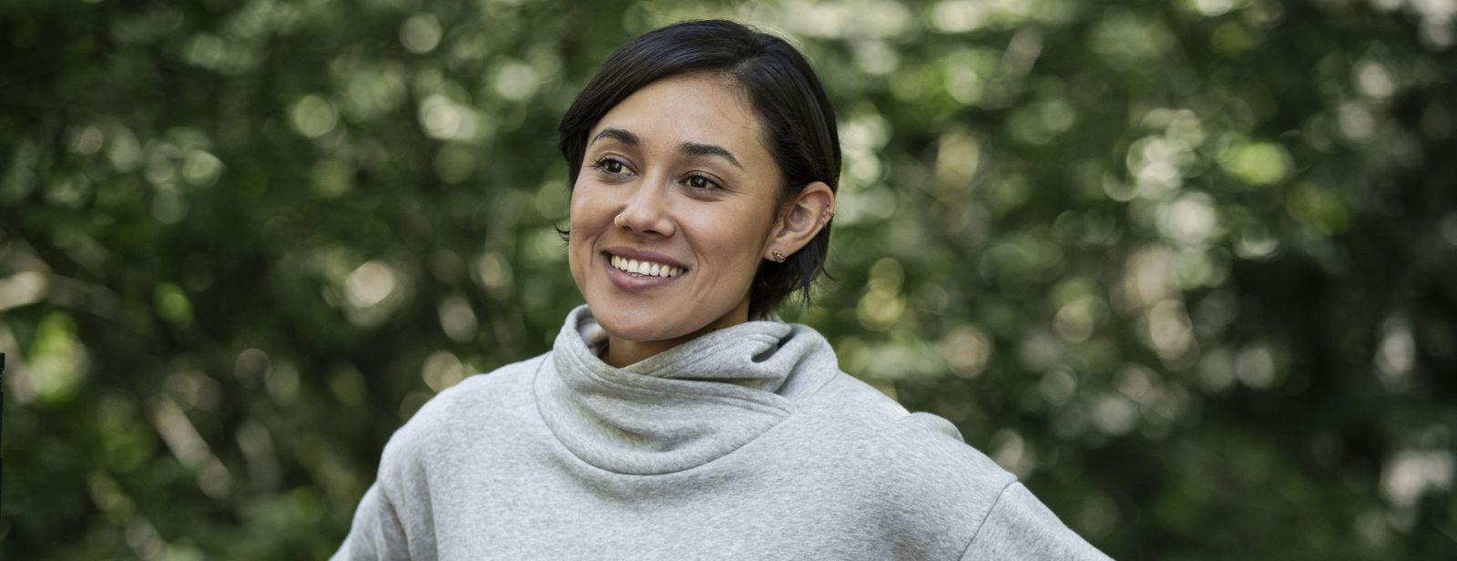 Image of woman smiling in the woods.