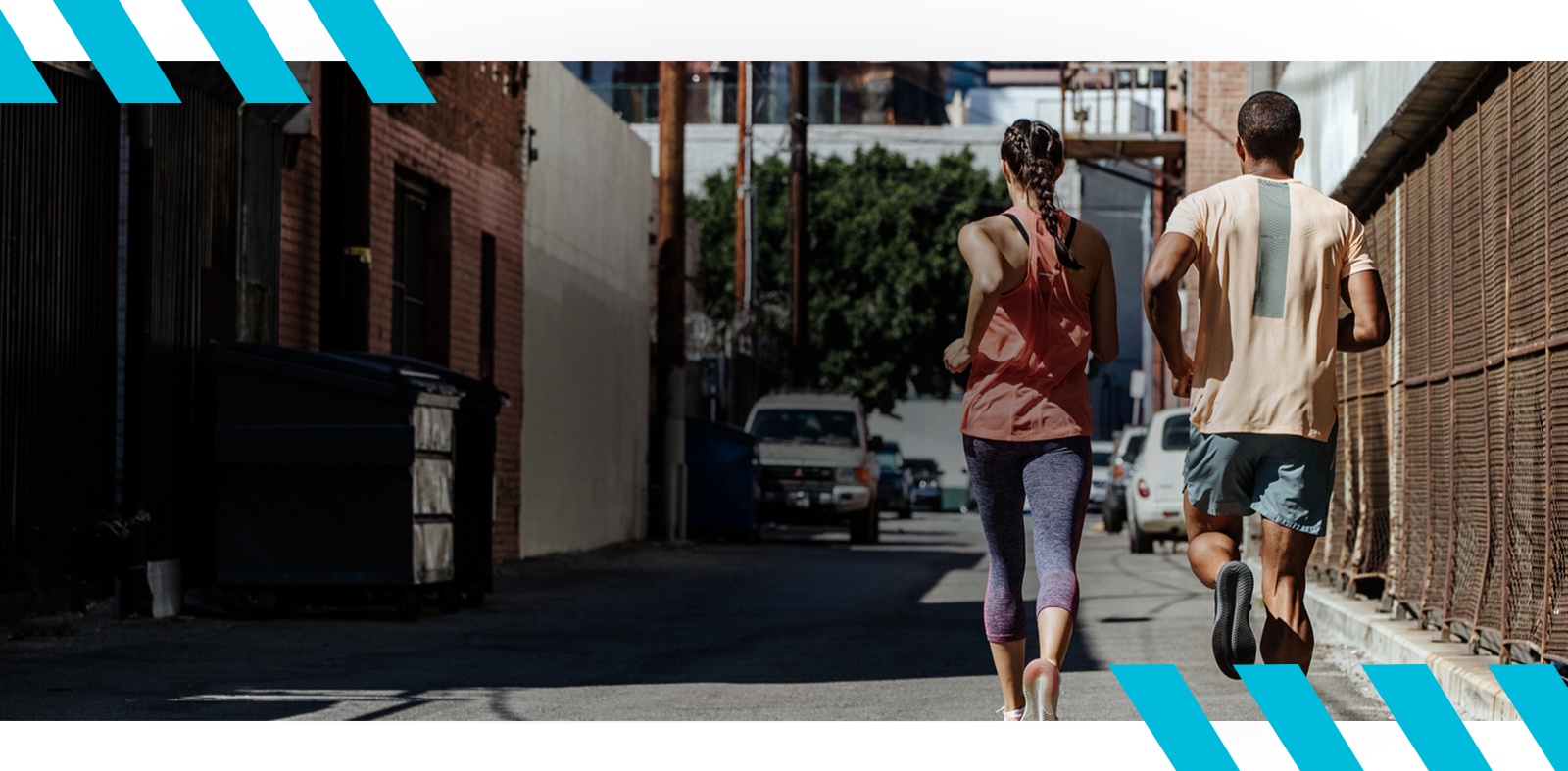 Man and woman running, dressed in workout clothes.