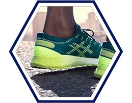 Closeup on heel of green running shoes.
