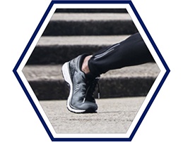 Closeup of a flexed gray running shoe.
