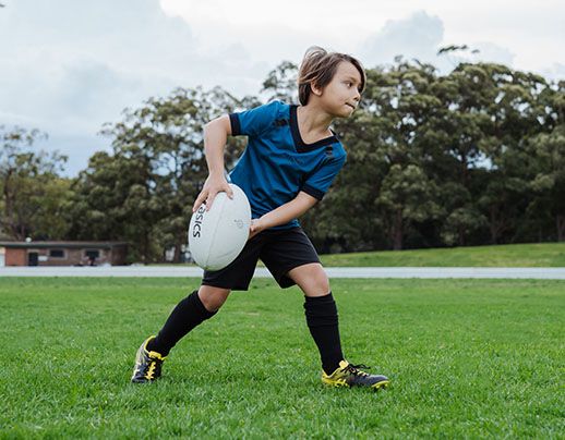 Kid throwing rugby ball