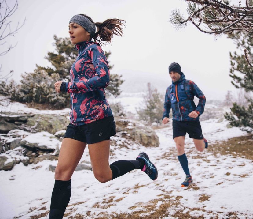 man and woman trail running; winter & snow