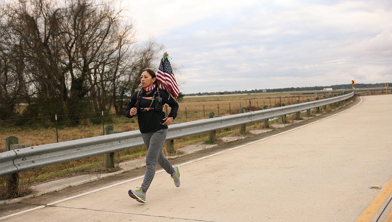 Lupita running with American flag