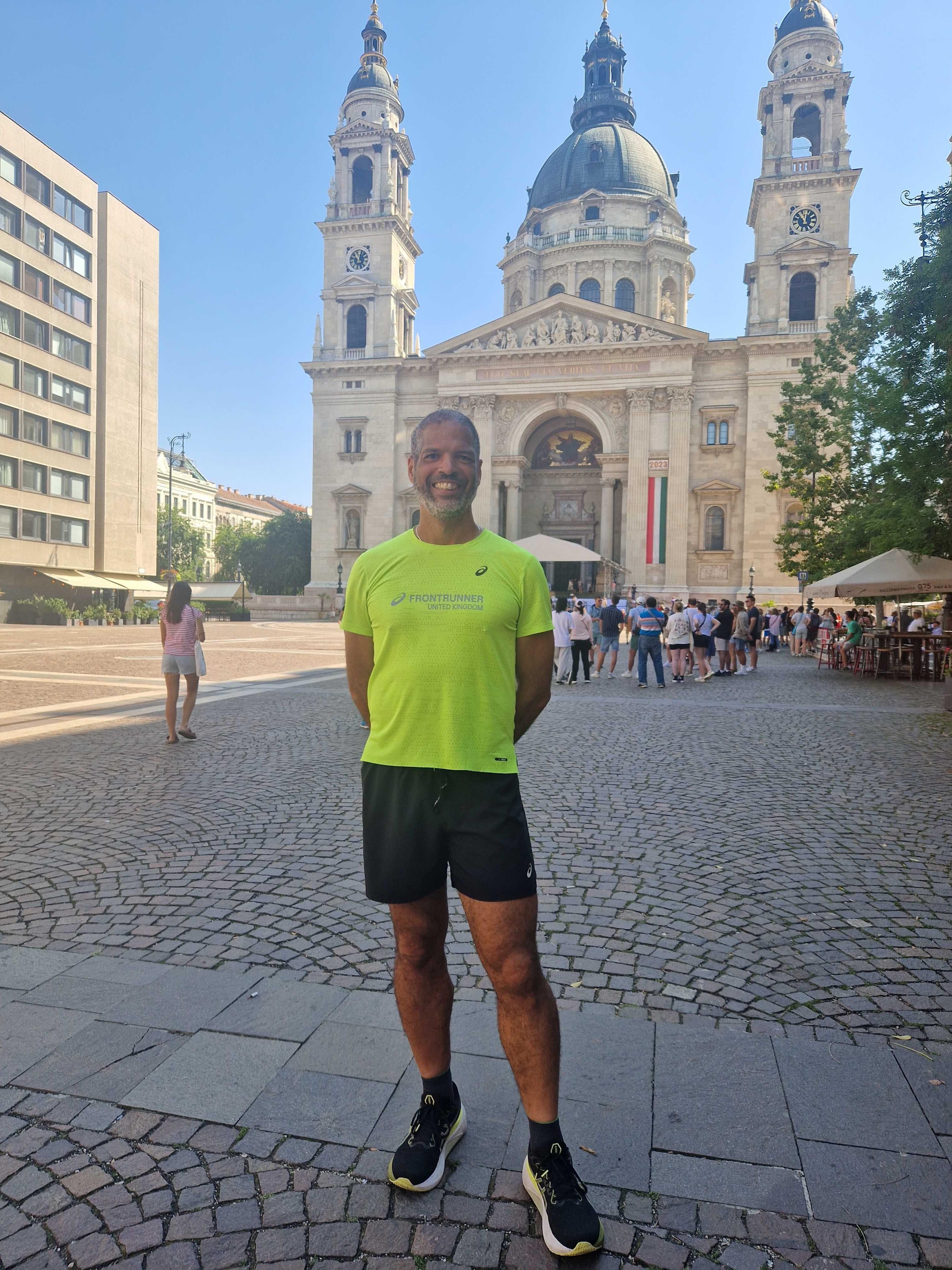 Sonny Peart in running kit, stood in front of a St Stephen's Basilica in Budapest.